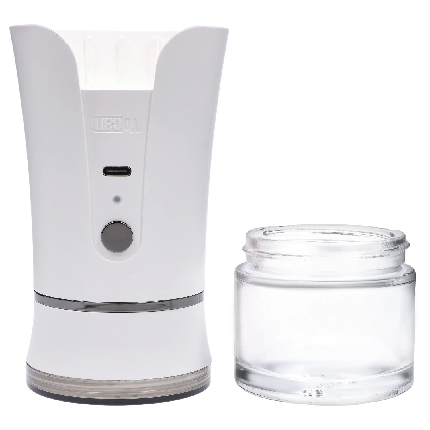 Left-front close-up of the ivory Yocan iShred Electronic Grinder showing its curved top, front button and USB-C port next to a clear glass collection jar.