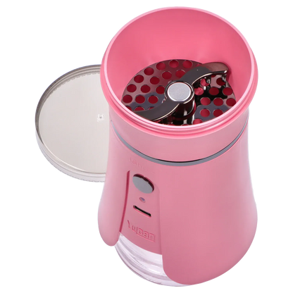 Top-down close-up of the open Yocan iShred Electronic Grinder – Pink showing the circular perforated grinding plate and twin metal blades inside.