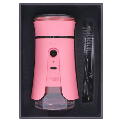 Top-down view of the pink Yocan iShred Electronic Grinder nestled in black foam with its USB cable and brush to the right.