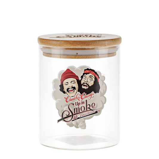 A front view of the C&C Cookie Jar Stash Jar-Large featuring cartoon character faces on a clear glass container.