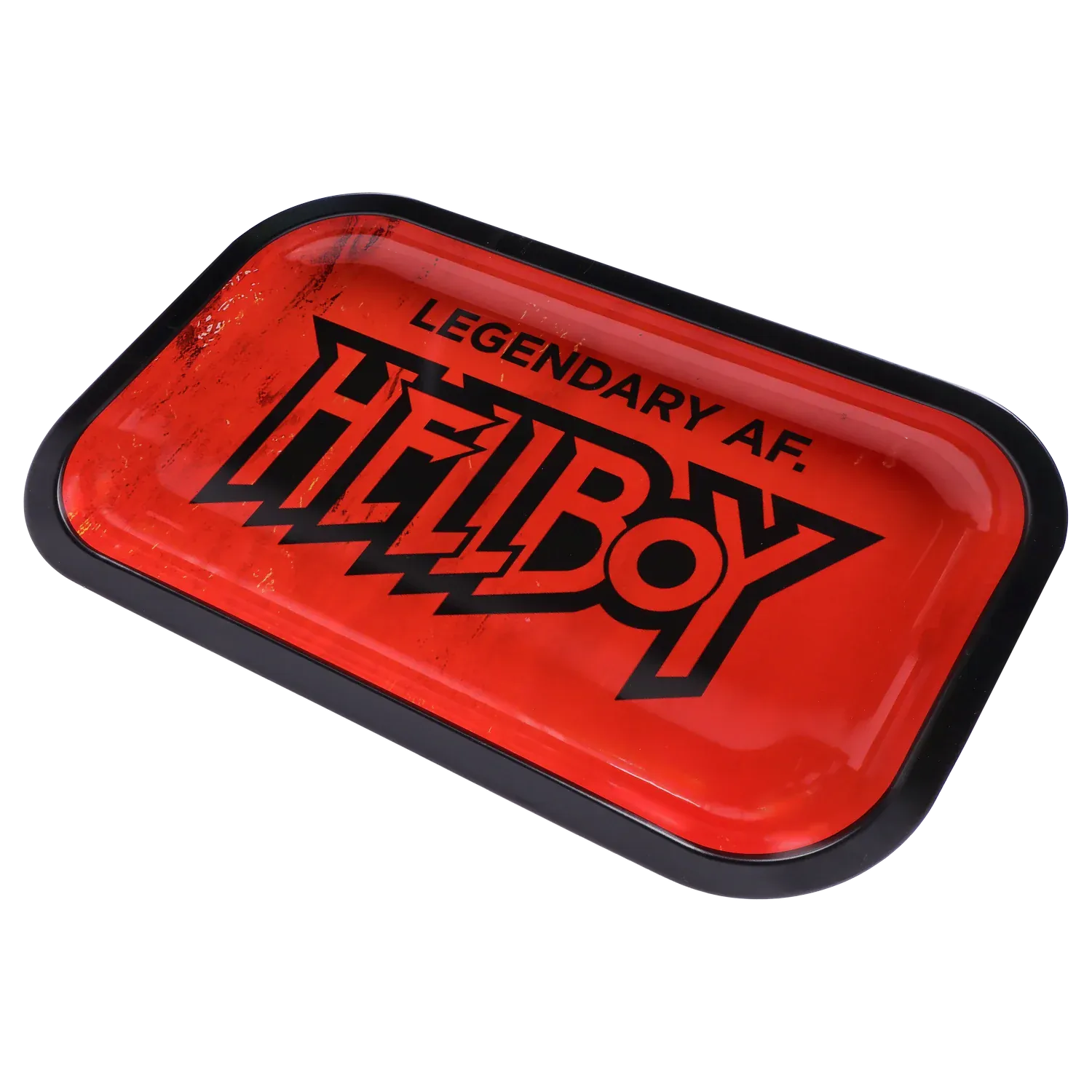 Angled close-up of the red Hell Boy Legendäres Rolling Tray - Mittel with bold black logo and scuffed glossy surface inside a black rim