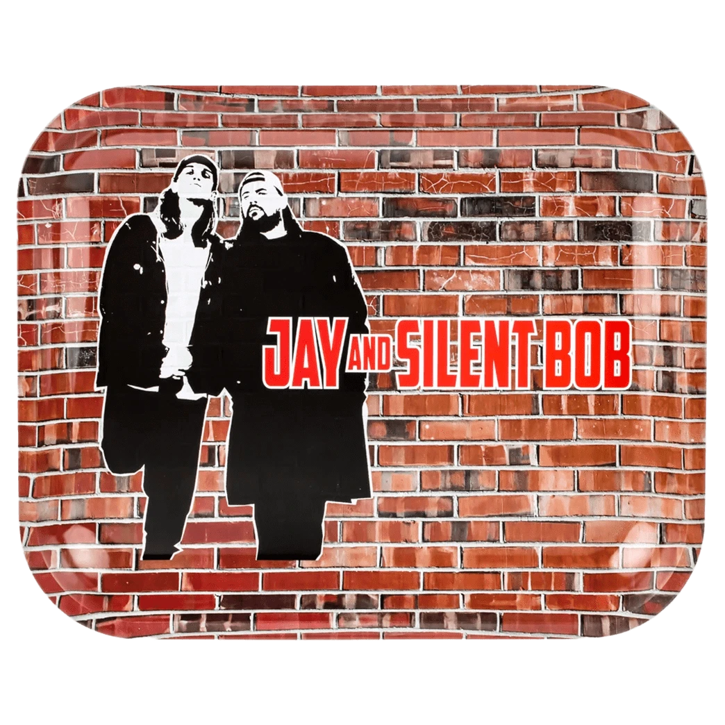 Top-down view of the JSB Jay & Silent Bob Wand Rolling Tray - Groß showing stencil-style black silhouettes of Jay and Silent Bob against a textured red brick wall background with bold red text.