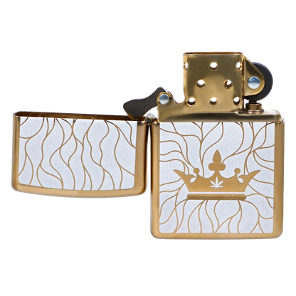 Close-up front view of the gold-and-white Zippo lighter from the Queen of Bud: Clarity Ritual Box – Candle, Zippo, and Crystal, showing its open lid, crown motif, and flowing line pattern.