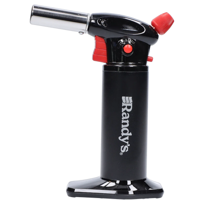 Side profile of Randy's Fahrenheit Butane Torch - Black showing the upright black cylinder with white logo, angled metal nozzle, and red control accents.