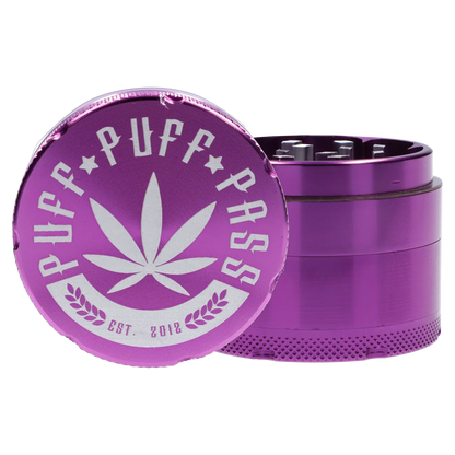 Close-up front view of the purple Puff Puff Pass Aluminum Grinder 4pc -Purple-50mm showing the engraved leaf logo on the lid and the textured grinder body.