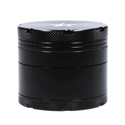 A front view of the black, four-piece Famous X 50mm Grinder, showing its textured metal construction and cylindrical shape.