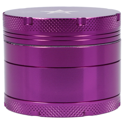 Close-up, straight-on view of the purple Famous X 4 pc Grinder -Purple - 50mm showing its textured top edge, smooth middle chambers, and metallic finish.