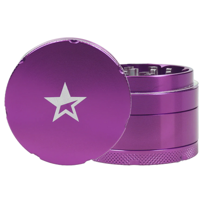 Close-up front angle of the Famous X 4 pc Grinder -Purple - 50mm showing its purple lid with a silver star and exposed toothed interior.