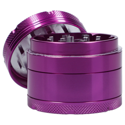 Close-up angled view of the purple Famous X 4 pc Grinder -Purple - 50mm showing its textured top, exposed internal teeth, and stacked cylindrical chambers.