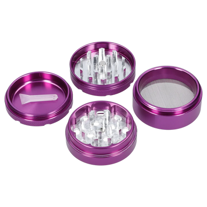 Top-down view of the disassembled Famous X 4 pc Grinder -Purple - 50mm showing four metallic purple stacked chambers and a plastic scraper on a white background