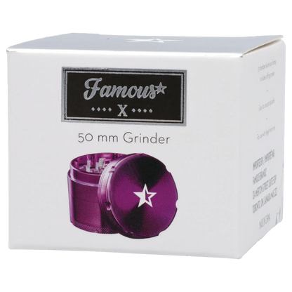 Angled front view of the Famous X 4 pc Grinder -Purple - 50mm packaging showing a purple grinder with a white star on its lid against a white box.