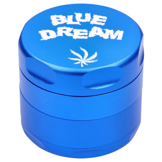 Close-up top three-quarter view of the blue Puff Puff Pass Strains Blue Dream Grinder-Blue showing white "BLUE DREAM" text and a small leaf motif on the lid.