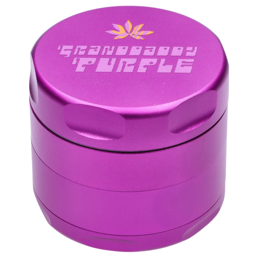 Close-up, angled top view of the purple Puff Puff Pass Strains Granddaddy Grinder-Purple showing engraved lid text and knurled grip.