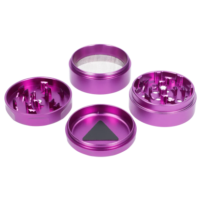 Top-down view of the disassembled purple Puff Puff Pass Strains Granddaddy Grinder-Purple showing four circular aluminum sections and a triangular scraper.