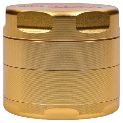 Close-up straight-on view of the champagne gold Puff Puff Pass Strains GG4 Grinder-Champagne Gold showing textured ridges and finger notches.