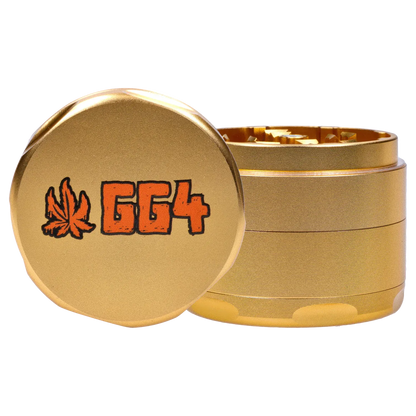 Close-up front view of the champagne gold Puff Puff Pass Strains GG4 Grinder-Champagne Gold showing the stacked metal sections and orange "GG4" logo with a leaf.