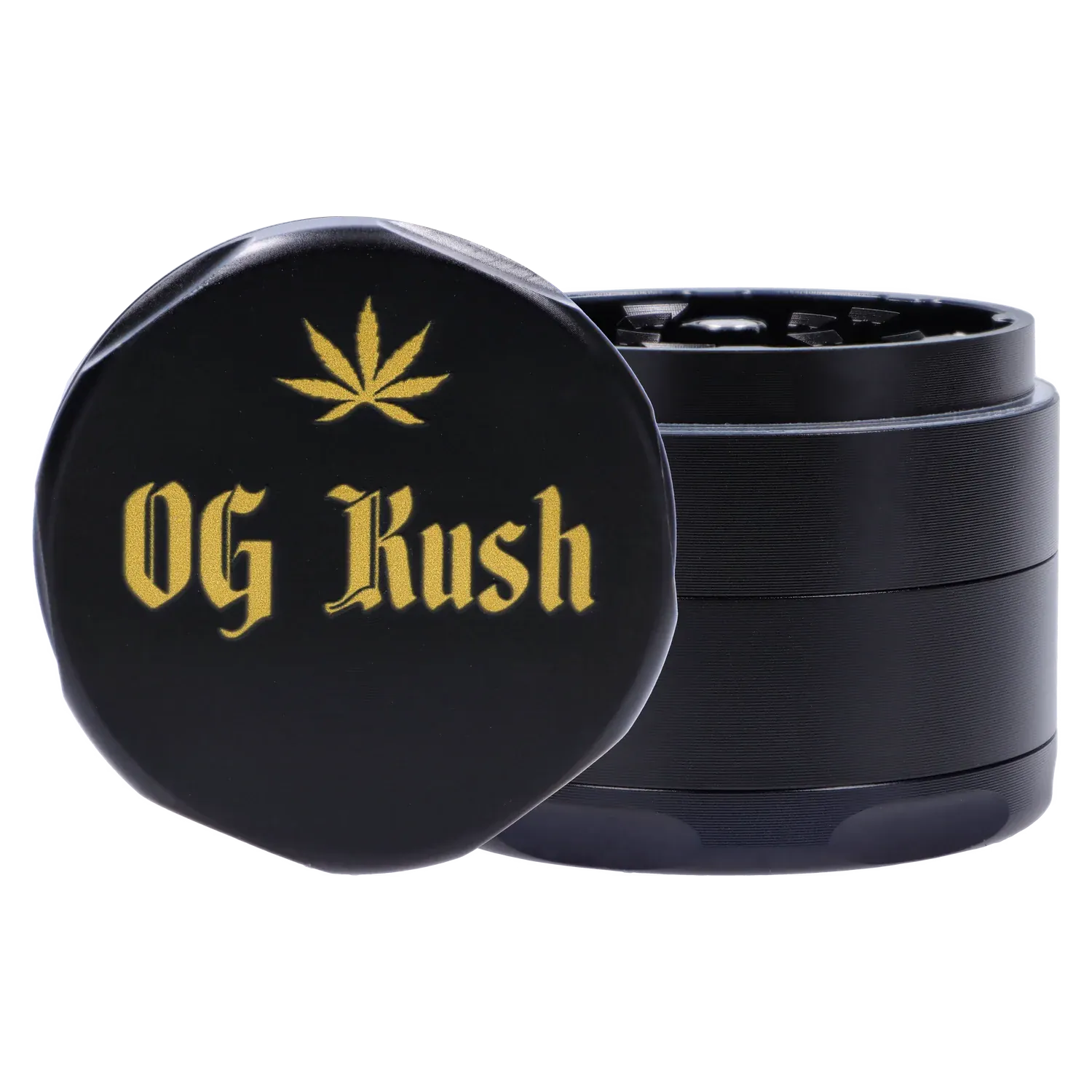 Close-up front three-quarter view of the black Puff Puff Pass Strains OG Kush Grinder-Black with gold "OG Kush" text and a gold leaf emblem on the lid.