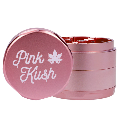 Close-up front view of the Puff Puff Pass Strains Pink Kush Grinder-Light Pink showing the metallic pink lid with white "Pink Kush" script and stacked grinder layers.
