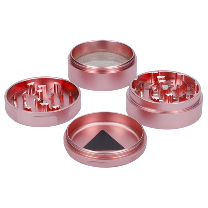 Top-down view of the disassembled Puff Puff Pass Strains Pink Kush Grinder-Light Pink showing four metallic pink pieces with sharp teeth and a mesh screen.