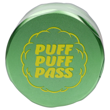 Top-down close-up of a green Puff Puff Pass Strains Sour Diesel Grinder-Green lid with bold yellow "PUFF PUFF PASS" text.