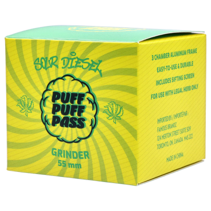 Angled close-up of the green Puff Puff Pass Strains Sour Diesel Grinder-Green box with sunburst graphics and bold logo on a white background
