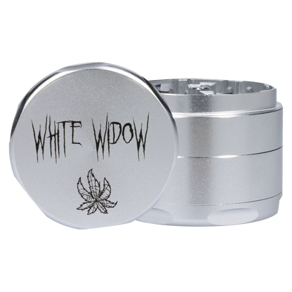 Close-up front-angle view of the silver Puff Puff Pass Strains White Widow Grinder-Silver showing the engraved "WHITE WIDOW" text and leaf motif on the lid.