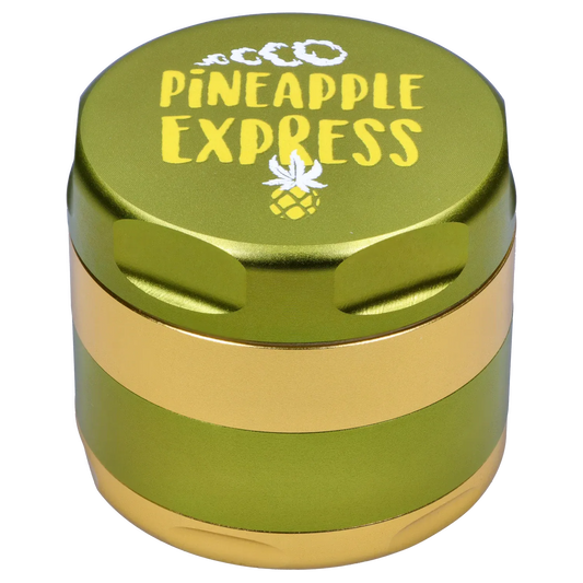 Close-up top-down view of the green and yellow Puff Puff Pass Pineapple Express Strain Grinder showing its textured lid and pineapple logo.