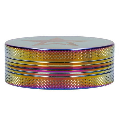 Front view of the Famous X - Prism 2 pc Grinder, a rainbow-colored, 55mm grinder with a textured metallic surface.