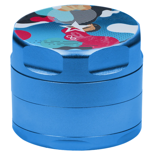 Close-up angled view of the Famous Design Aquarius Aluminum 4 pc Grinder - Aqua showing its metallic blue stacked chambers and a colorful patterned top.