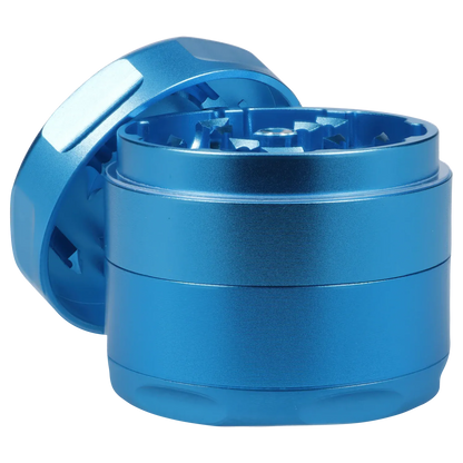 Close-up angled shot of the blue Famous Design Aquarius Aluminum 4 pc Grinder - Aqua showing the open top teeth and textured cylindrical sides.