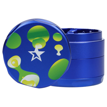 Close-up front view of the Famous Design Privilege Aluminum 4pc Grinder - Blue showing its blue metal finish and green-yellow bubble pattern on the lid.