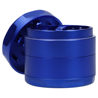 Close-up side view of the blue Famous Design Privilege Aluminum 4pc Grinder - Blue showing the textured cylindrical body and exposed interlocking teeth.