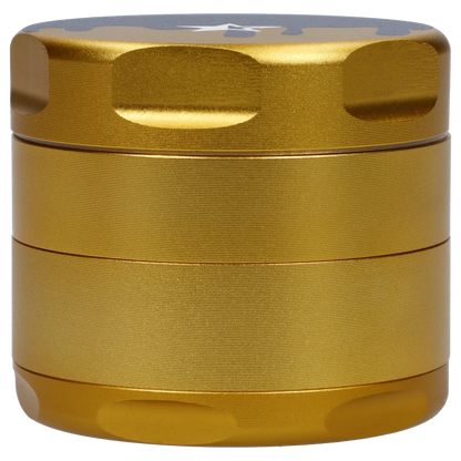Close-up front view of the gold Famous Design Surrender Aluminum 4 pc Grinder showing textured grip bands and rounded top indents.