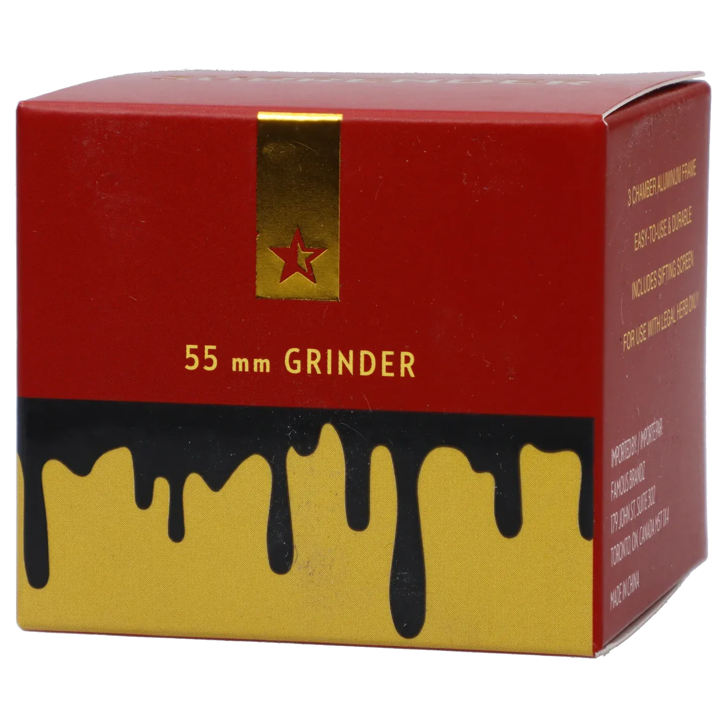 Angled close-up of the red and gold box reading "Famous Design Surrender Aluminum 4 pc Grinder - Gold" with a gold star strip and black drips over yellow.