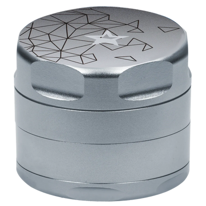 Close-up angled view of the Famous Design Space Aluminum 4pc Grinder - Silver showing its textured silver finish, scalloped grip edges, and geometric star design on the top.