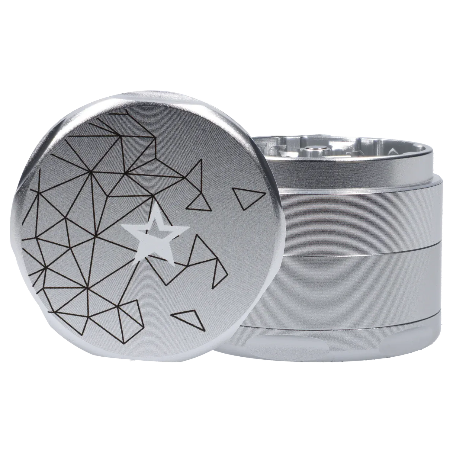 Angled close-up of the silver Famous Design Space Aluminum 4pc Grinder showing its geometric star pattern on the top and stacked textured body