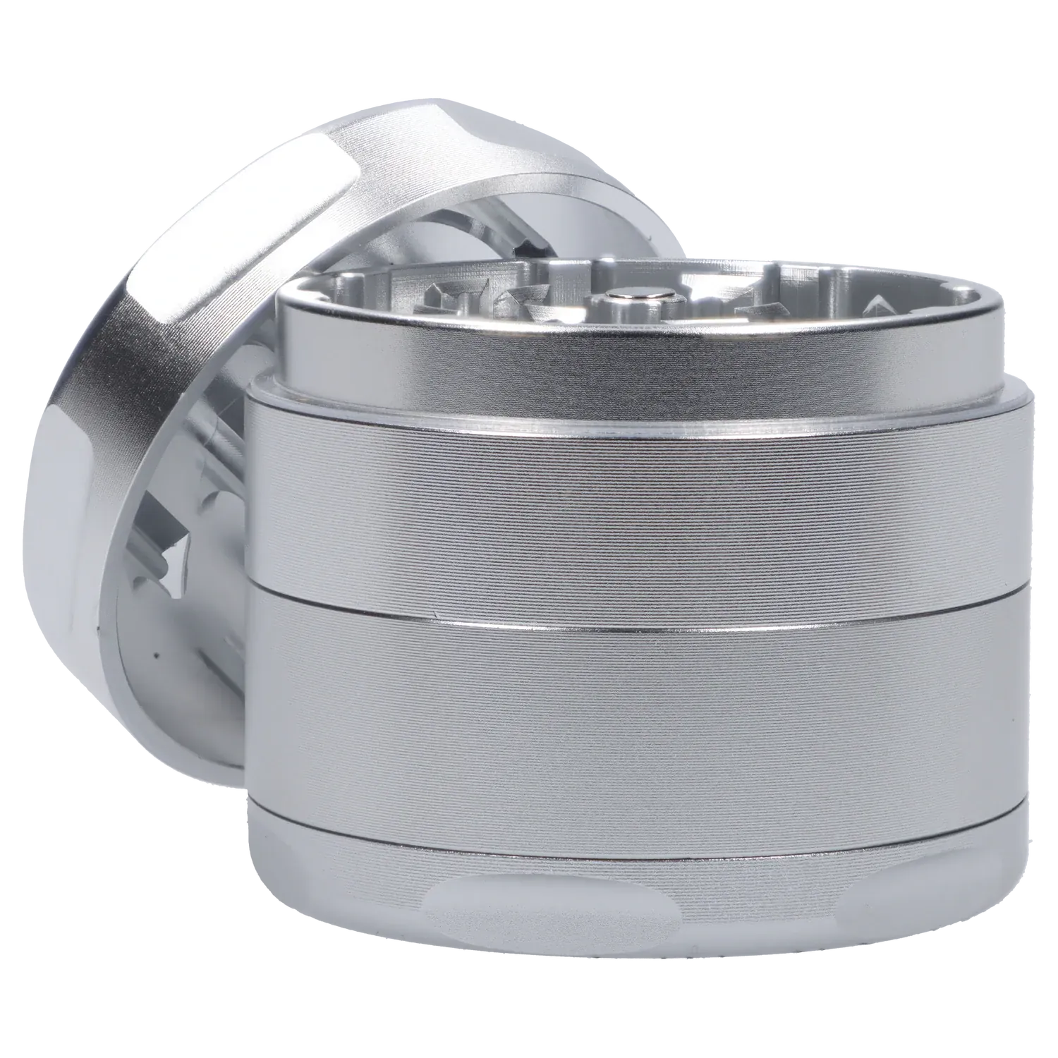 Close-up angled view of the silver Famous Design Space Aluminum 4pc Grinder showing the textured cylindrical body and open top with visible teeth.
