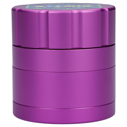 A close-up, angled view of the Atomik Pixelated 55 mm 3-Stage Grinder, showcasing its metallic, multi-tiered construction.