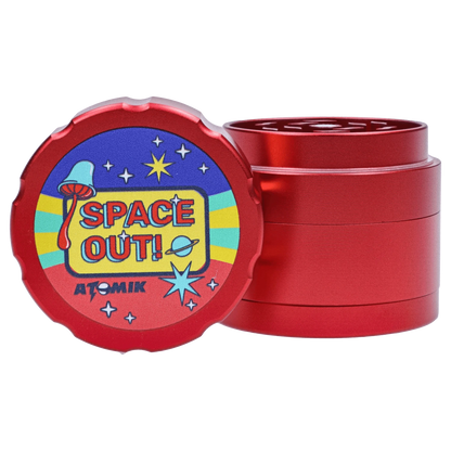 A close-up of the Atomik Spaced 55 mm 3-Stage Grinder, showcasing its stacked, metallic, circular design.