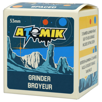 Close-up of the Atomik Spaced 55 mm 3-Stage Grinder, with a metallic finish, against a dark, starry background.