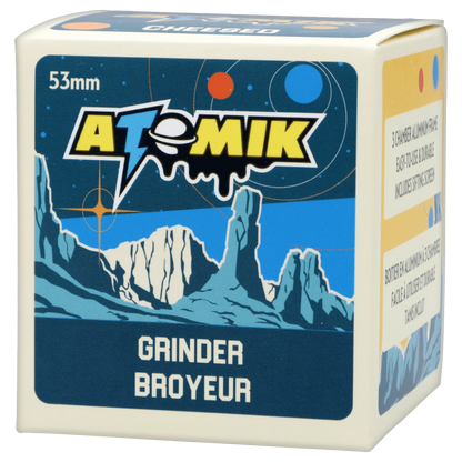 Front view of the Atomik Cheesed 55 mm 3-Stage Grinder, displaying a bold logo on its metallic, textured surface.