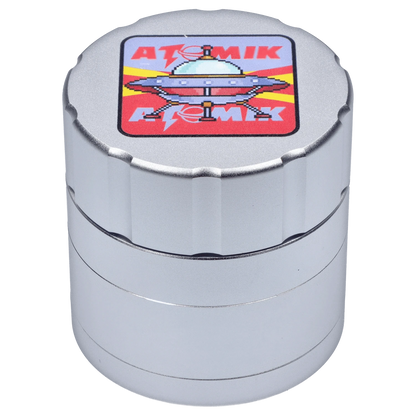 A top-down view of the Atomik Landed 55 mm 3-Stage Grinder, showcasing its metallic finish and tiered design.