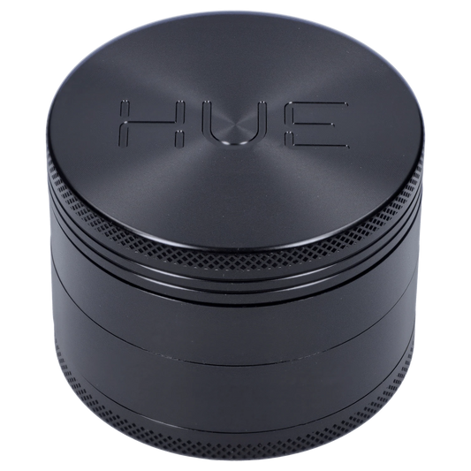 Front view of the Hue 3-Stage Grinder in black, showing its cylindrical shape and textured surface.