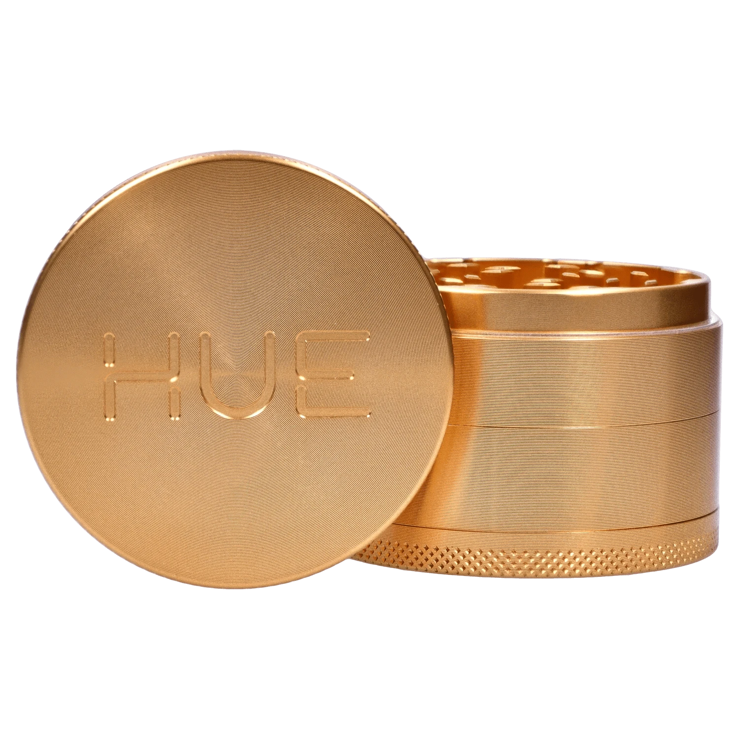 A close-up of the Hue 3-Stage Grinder in champagne gold, showing its stacked, cylindrical design from a slightly elevated angle.