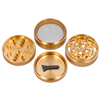 A top-down view of the disassembled Hue 3-Stage Grinder in champagne gold, showcasing its multi-tiered design and metallic finish.
