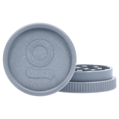 Close-up front view of a light grey Ongrok - Degradable Grinder - 24/box Assorted Colours showing the textured lid with embossed logo and the ridged grinder base.