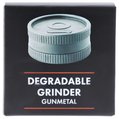 Close-up front view of a gunmetal ridged grinder on black packaging labeled Ongrok - Degradable Grinder - 24/box Assorted Colours.