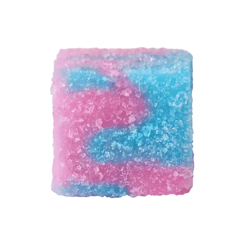 Close-up top view of a square, sugar-coated gummy in pink and blue tones from Glenn's No. 16 Rosin Cotton Clouds Gummies.