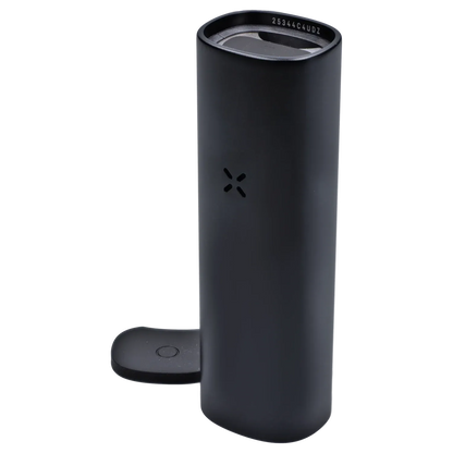 Tall angled close-up of the Onyx PAX Flow Dry Herb Vaporizer showing its matte black cylinder, top mouthpiece and docking tab.