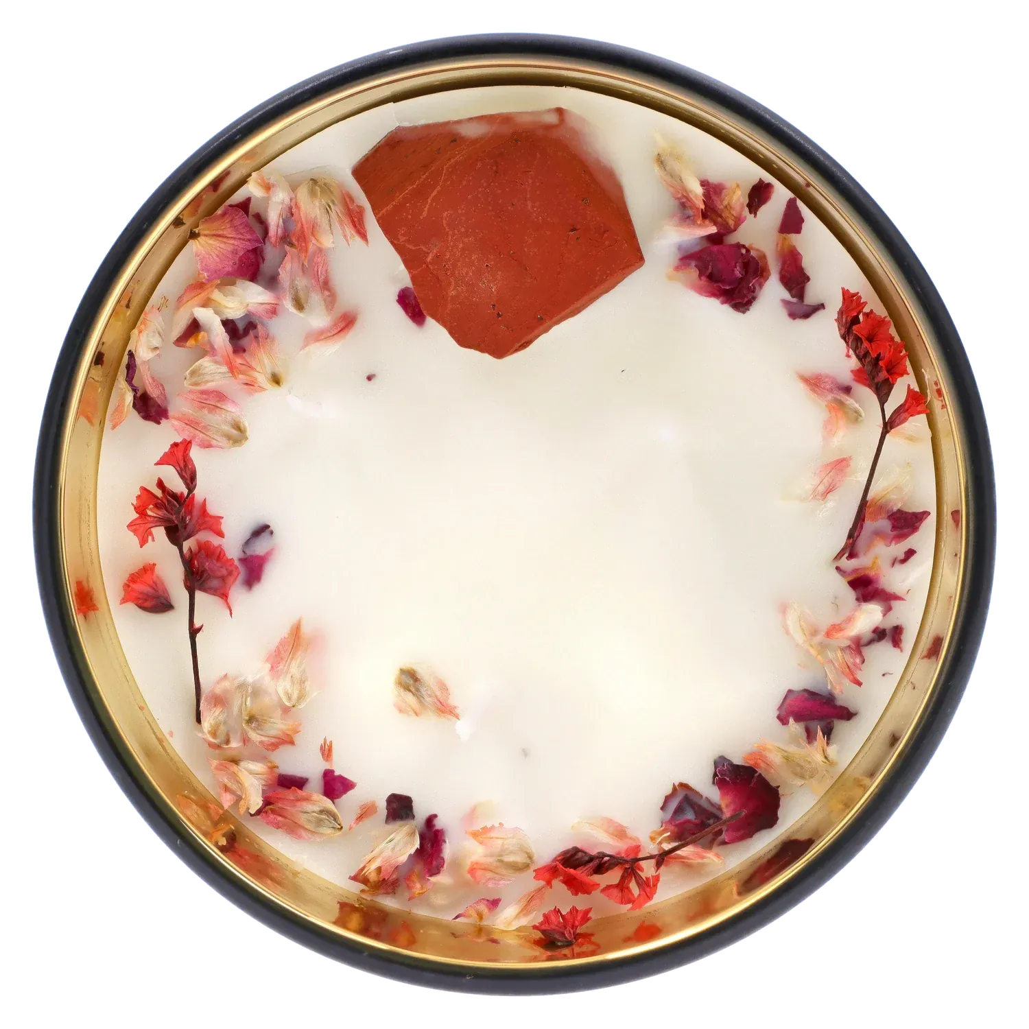 Top-down view of the Queen of Bud: Passion Ritual Box – Candle, Zippo, and Crystal showing a white wax candle rimmed with dried pink and red flower petals and a single red crystal fragment.